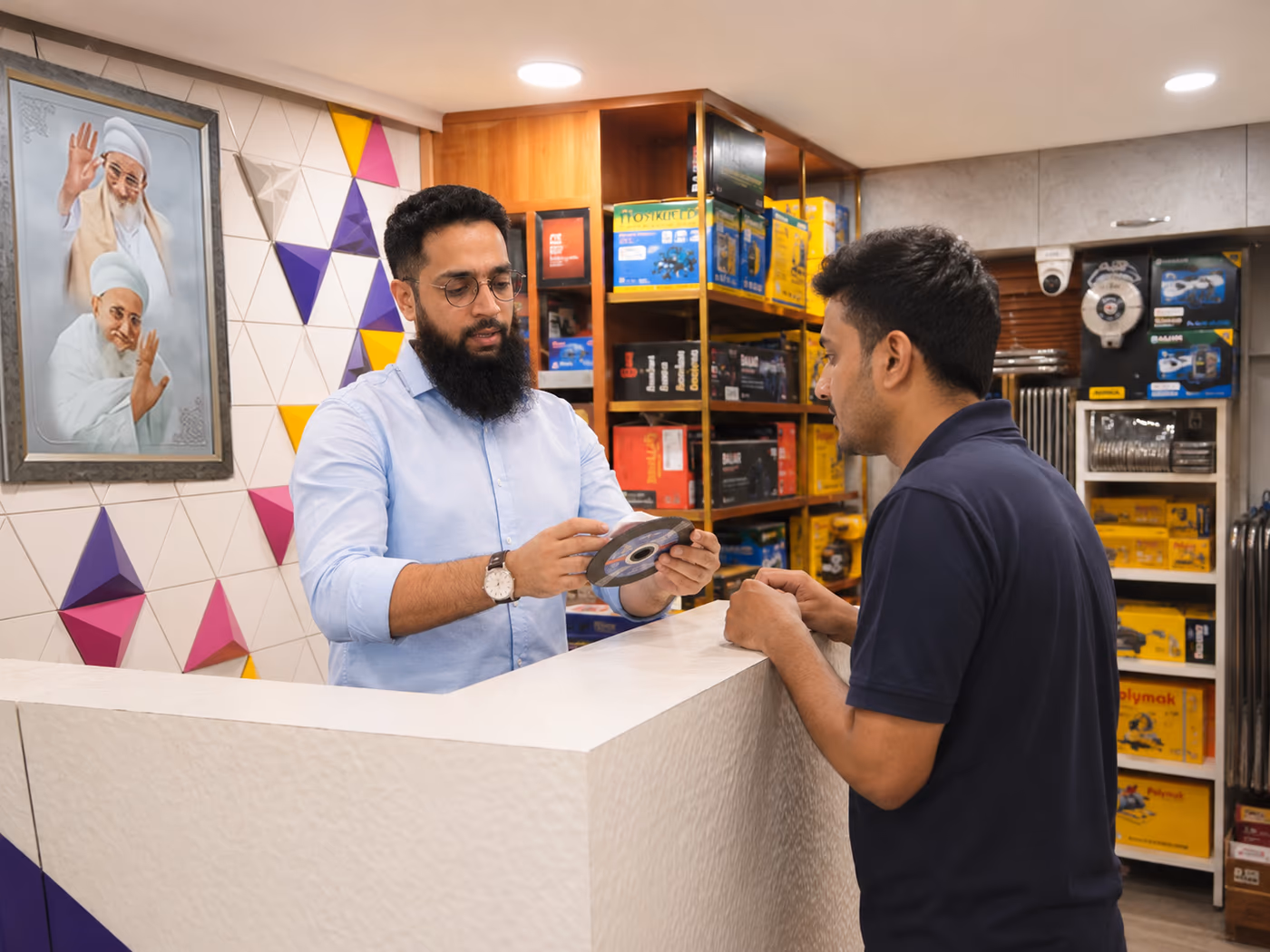 Saif Trade team helping a customer at the store counter
